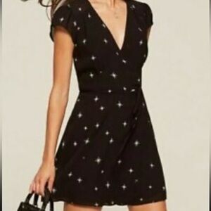 Reformation black star print mini wrap dress size xs